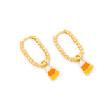 A pair of gold hoop earrings with dangling candy corn charms, shown on a plain white background.