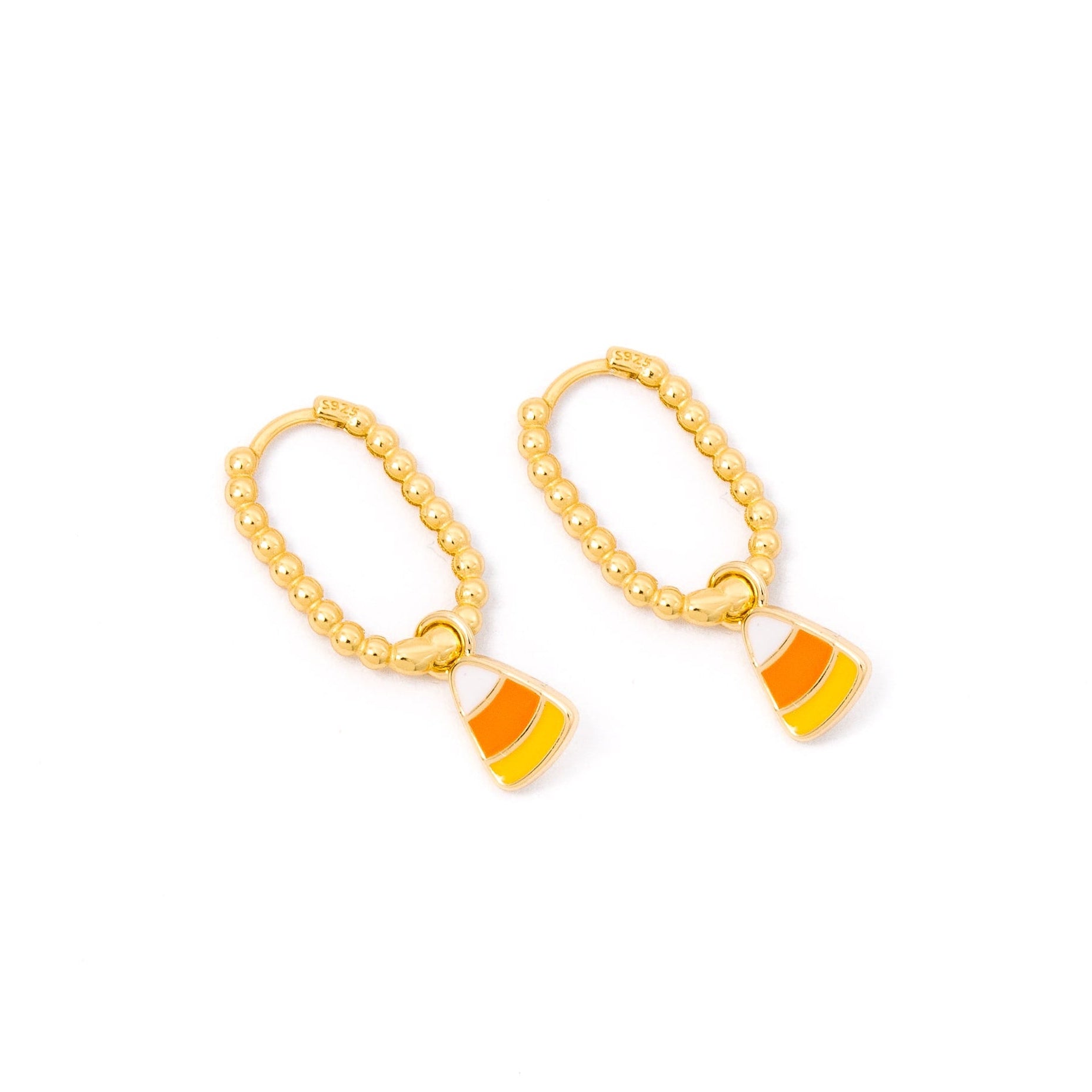 A pair of gold hoop earrings with dangling candy corn charms, shown on a plain white background.