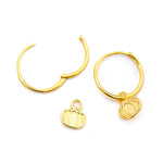 Gold-toned hoop earrings with small pumpkin charms, displayed on a clean white background.