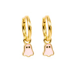 A pair of gold huggie hoop earrings with dangling ghost charms filled with light pink enamel, shown on a plain white background.