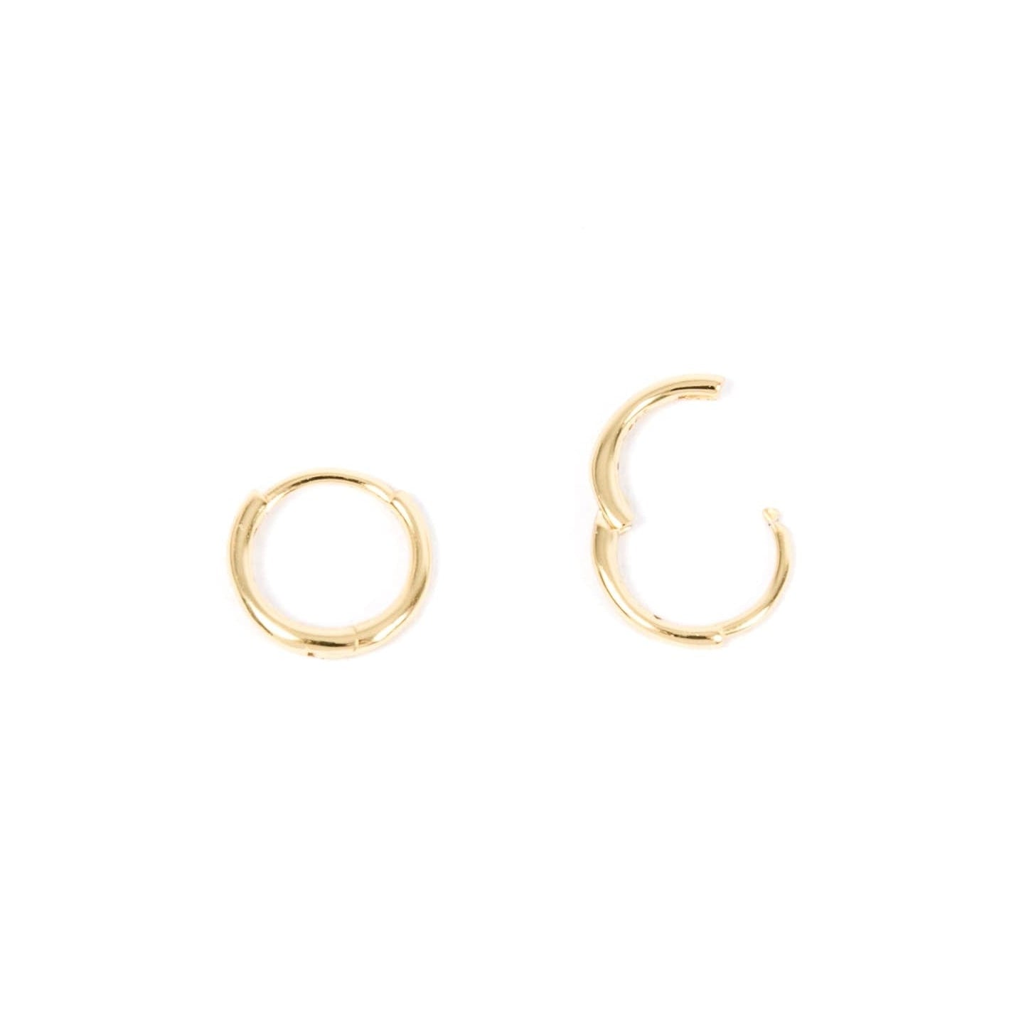 Gold hoop earrings on a white background, showing unique huggie clasp.